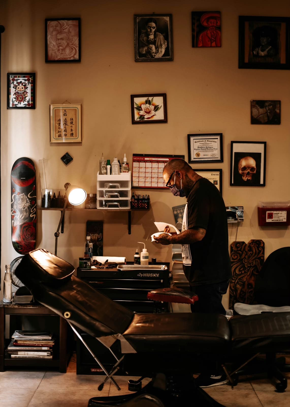 Tatuador profesional preparando su espacio de trabajo en un estudio real.